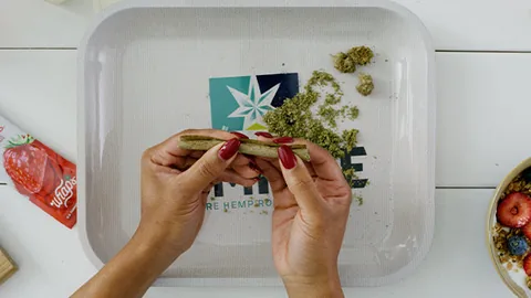 Hands rolling a Hempire hemp wrap