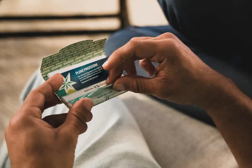 Hands rolling with a Hempire Pure Freedom hemp rolling paper